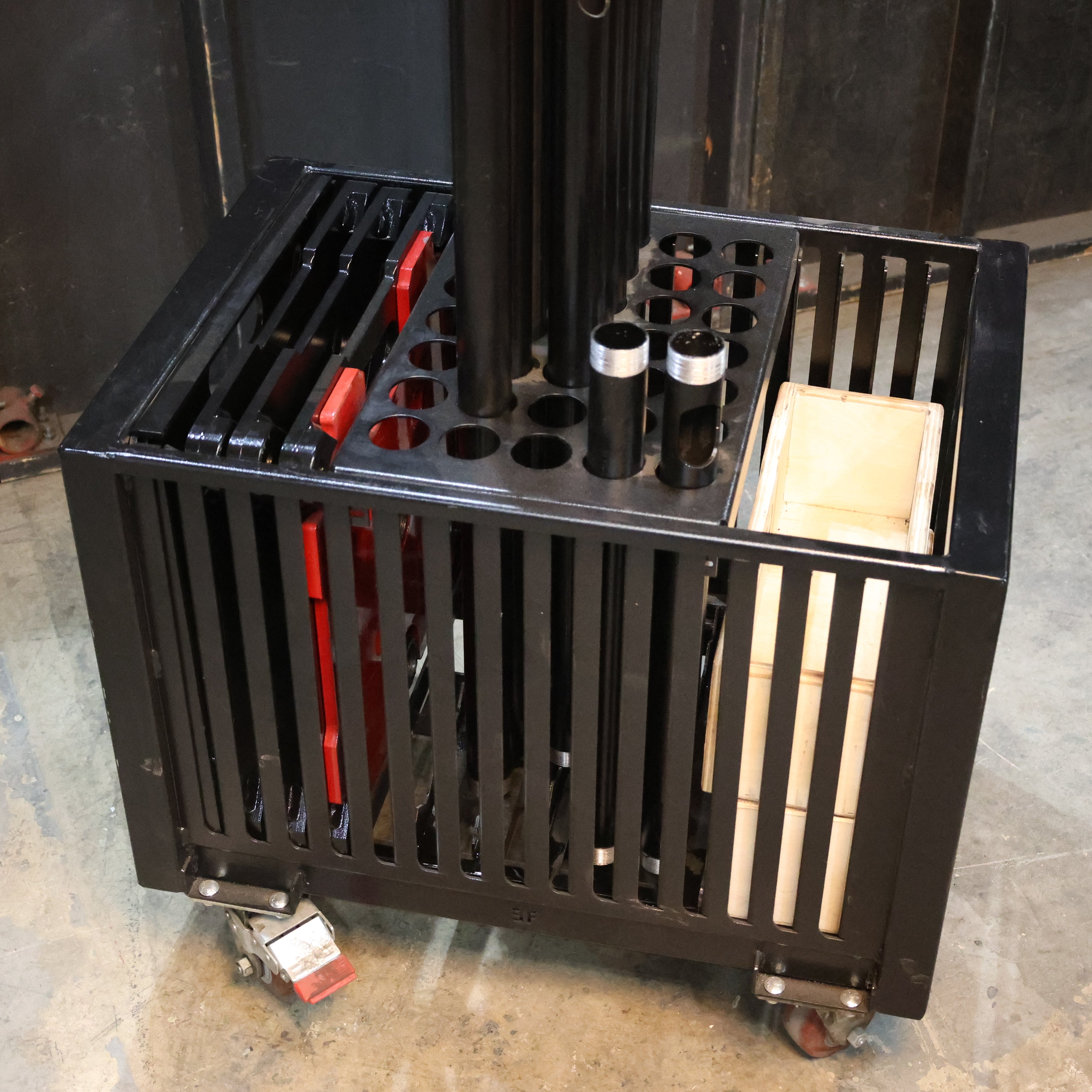 Black cart for truss bas plates with various tools and accessories on a concrete floor